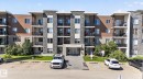 Modern multi-story building featuring stone veneer and horizontal siding - 205 11816 22 Avenue, Edmonton, AB 