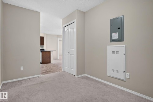 Interior room featuring neutral wall paint and plush carpet flooring - 205 11816 22 Avenue, Edmonton, AB 