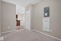 Interior room featuring neutral wall paint and plush carpet flooring - 