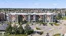 Multi-story building featuring a facade of stone cladding and beige panels - 205 11816 22 Avenue, Edmonton, AB 