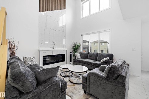 Living area featuring soaring ceilings and contemporary finishes - 403 Pine Point, Leduc, AB 