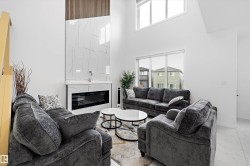Living area featuring soaring ceilings and contemporary finishes - 