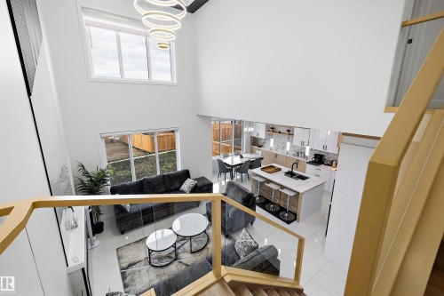 Spacious open-concept living area featuring high ceilings and abundant natural light - 403 Pine Point, Leduc, AB 