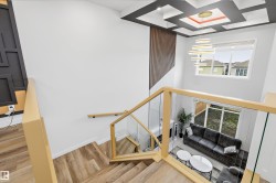 Grand staircase with wood-finish treads and glass railings - 