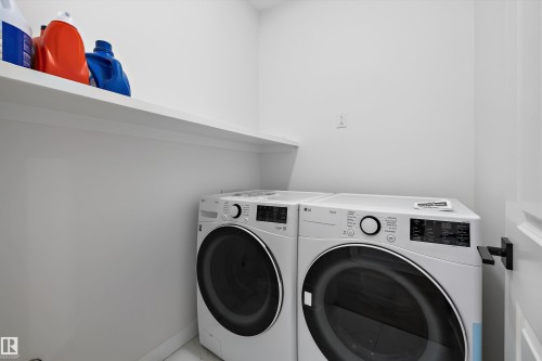 Dedicated laundry space featuring a white built-in shelf and light-colored walls - 403 Pine Point, Leduc, AB 