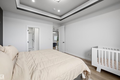 Bright room featuring a tray ceiling with recessed lighting and crown molding - 403 Pine Point, Leduc, AB 