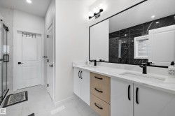 Double vanity with integrated sinks, quartz countertop, and matte black fixtures - 