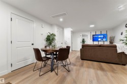 Spacious room featuring light wood-finish flooring, recessed lighting, and white baseboards - 