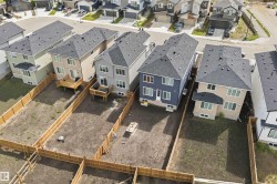 Aerial view showcasing multiple properties with undeveloped rear yards and privacy fencing - 