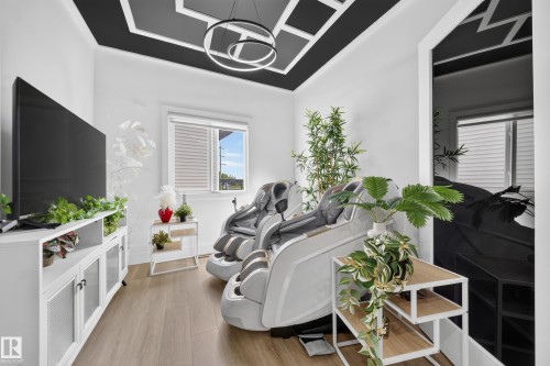 Room featuring a distinctive black and white geometric ceiling design with a contemporary circular light fixture - 626 Astoria Way, Devon, AB 