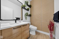 Contemporary bathroom featuring a wood-finish vanity with a white countertop and rectangular undermount sink - 