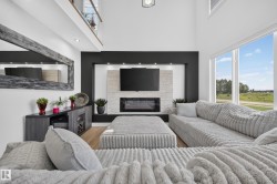 Living area featuring a two-story ceiling and a large picture window - 