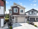 Contemporary exterior featuring mixed siding in brown and beige tones, accented with white trim - 626 Astoria Way, Devon, AB 