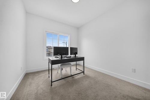 Bright room featuring neutral carpeting, white walls, and a large window with white trim - 626 Astoria Way, Devon, AB 