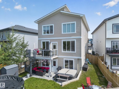 Three-story residence featuring light-toned siding and white trim - 626 Astoria Way, Devon, AB 