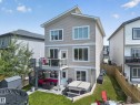 Three-story residence featuring light-toned siding and white trim - 626 Astoria Way, Devon, AB 