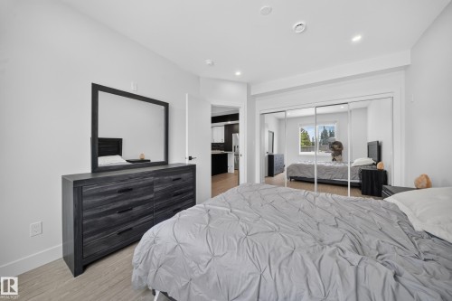 Recessed lighting illuminates this bright room featuring wood-finish flooring and a spacious mirrored closet - 626 Astoria Way, Devon, AB 