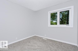 Room featuring light grey painted walls and grey carpet flooring - 