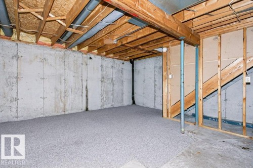Unfinished basement offering concrete walls, exposed ceiling joists, and a partial subfloor - 24 14511 52 Street, Edmonton, AB 