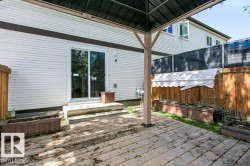 Outdoor wood-finish decking with a dark metal gazebo frame - 
