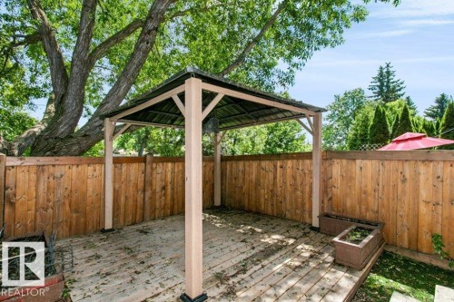 Outdoor patio featuring a light-colored gazebo with a dark roof - 24 14511 52 Street, Edmonton, AB 