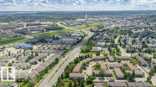 Expansive aerial view showcasing a developed residential area with a mix of single-family homes and multi-story apartment buildings - 24 14511 52 Street, Edmonton, AB 