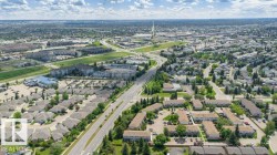 Expansive aerial view showcasing a developed residential area with a mix of single-family homes and multi-story apartment buildings - 