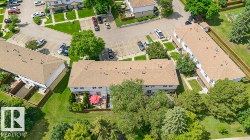 Aerial perspective showcasing multiple residential buildings with uniformly pitched roofs and individual patio spaces - 24 14511 52 Street, Edmonton, AB 