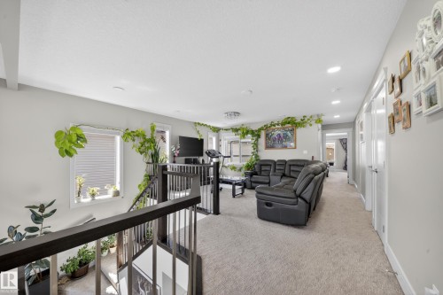 Open concept upper level featuring plush carpet flooring and recessed lighting - 1927 18 Street, Edmonton, AB 