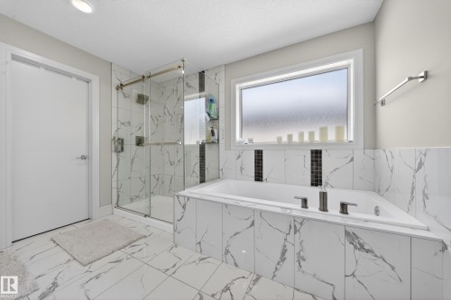 Bathroom featuring white marble-look tile flooring and wainscoting - 1927 18 Street, Edmonton, AB 