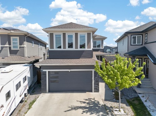 Contemporary residential exterior featuring dark gray siding with light trim accents - 1927 18 Street, Edmonton, AB 