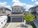 Contemporary residential exterior featuring dark gray siding with light trim accents - 1927 18 Street, Edmonton, AB 