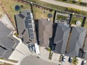 Residential property featuring a shingle roof, solar panel array, and a paved driveway - 1927 18 Street, Edmonton, AB 