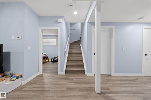 Light wood-finish flooring extending throughout the space - 1927 18 Street, Edmonton, AB 