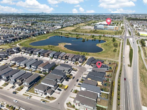 Aerial representation of a residential neighborhood featuring detached homes with varied rooflines and a central pond - 1927 18 Street, Edmonton, AB 
