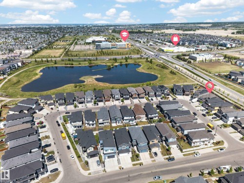 Residential development featuring a central pond with surrounding green spaces - 1927 18 Street, Edmonton, AB 
