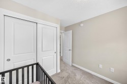 Neutral-toned wall with white trim featuring sliding panel doors - 