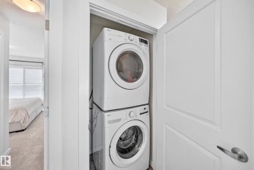 Dedicated laundry closet featuring a stacked washer and dryer - 118 655 Watt Boulevard Sw, Edmonton, AB 
