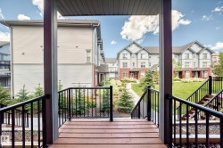 Outdoor wood-finish decking with black metal railings - 