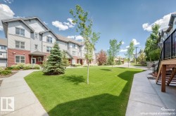 Townhome exteriors featuring red siding and light grey upper levels - 