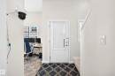 Entryway featuring a white door with a window, tile-patterned flooring, and light-toned walls - 118 655 Watt Boulevard Sw, Edmonton, AB 