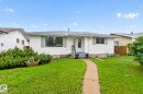 White siding exterior featuring a grey shingle roof and a concrete pathway - 7539 149A Avenue, Edmonton, AB 