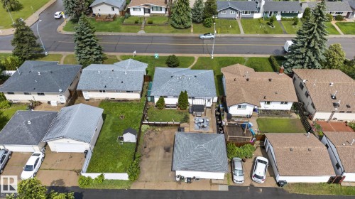 Aerial view showcasing multiple properties with fenced backyards - 7539 149A Avenue, Edmonton, AB 