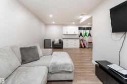 Recessed lighting illuminates this versatile space featuring wood-finish flooring - 