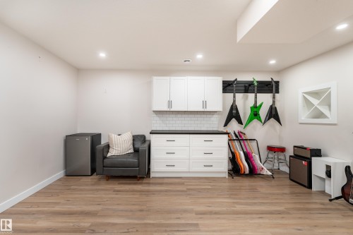Recessed lighting illuminates wood-finish flooring - 584 Meadowview Drive, Fort Saskatchewan, AB 