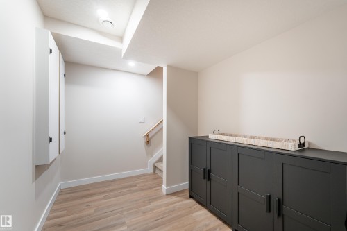 Recessed lighting illuminates the wood-finish flooring and light-toned walls - 584 Meadowview Drive, Fort Saskatchewan, AB 