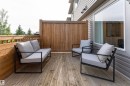 Private wood-finish deck featuring a full-height privacy fence and a large exterior window - 584 Meadowview Drive, Fort Saskatchewan, AB 