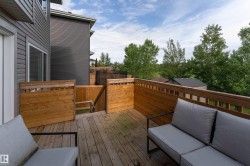 Wood-finish deck with privacy panels and railing - 