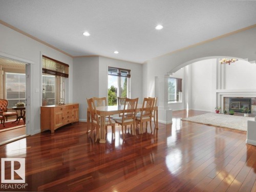 Open-concept interior featuring rich wood-finish flooring - 2423 Tegler Green, Edmonton, AB 