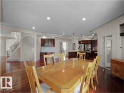 Spacious dining area with wood-finish flooring, recessed lighting, and an open concept layout - 